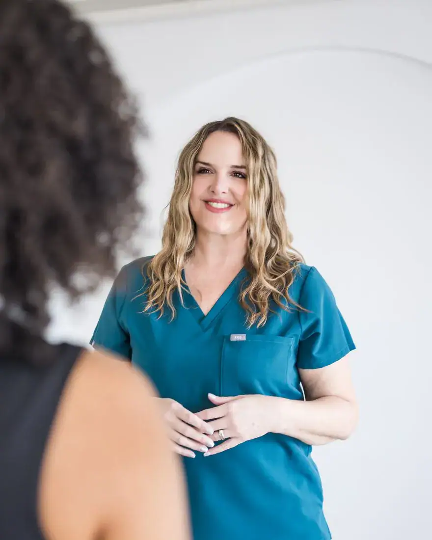A Restorica Wellness clinician talking with a patient at the Henderson clinic